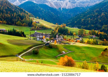 Beautiful autumn scenery with medieval church, scenic alpine meadows and colorful trees. Location place: Santa Maddalena (Santa Magdalena), South Tyrol, the Dolomite Alps, Italy. Royalty-Free Stock Photo #1522886717