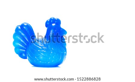 Isolated Blue plastic chicken piggy bank in side view on white background 
