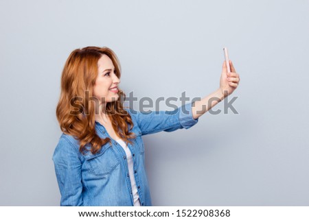 Close up side profile photo beautiful amazing she her curly lady hold arm hand telephone smart phone make take selfies tell speak skype wear casual blue jeans denim shirt isolated grey background