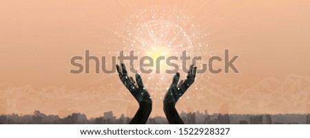 Hands holding earth and circle global network connection with data exchanges worldwide on city sunset background. 