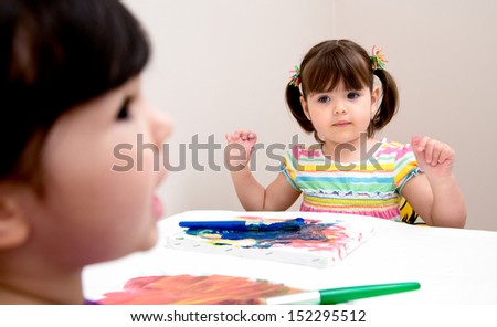 Young artist looks to her sister for painting advice