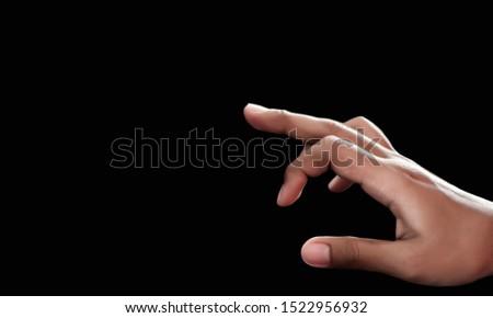 Pointing hand On a black background Royalty-Free Stock Photo #1522956932
