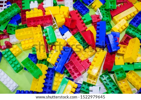 The background photo of multicolour toy plastic bricks.