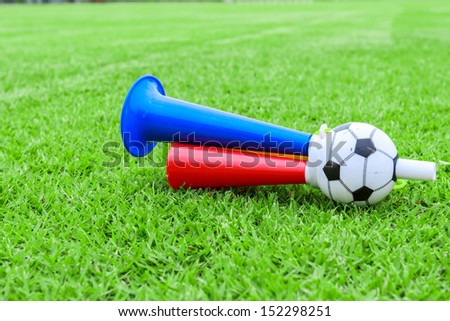 colorful football hooter on green grass Royalty-Free Stock Photo #152298251