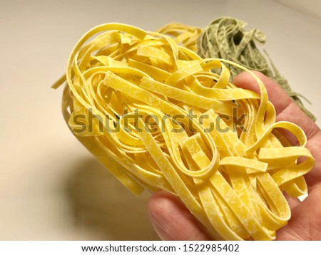 Italian pasta organic hand made conceptual Italian pasta made from green and yellow single serving different alternative compositions drawn on white table.