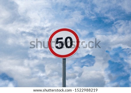 International traffic sign 'Speed limit' (to 50 km or miles per hour). Cloudy blue sky is on  background