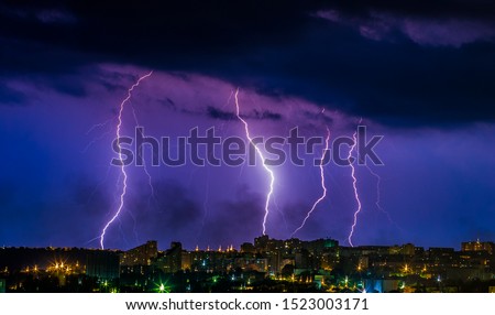 Flashes of lightning in the night sky. Lightning strike. Lightning near the factory. Night sky. Storm cloud. A flash of lightning. Industrial landscape before the storm