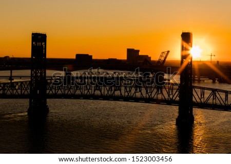 The John T. Alsop, Jr. Bridge in Jacksonville FL at a beautiful golden sunset. The bridge was previously named the Main Street Bridge and is still called that today.