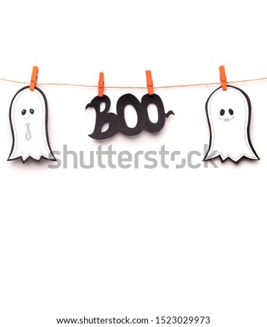 Boo. Halloween silhouettes hanging on rope as decorations, copy space