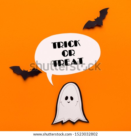 Trick or treat. Halloween cute ghost with bats and text on orange background