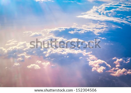 Sunrise above clouds during a flight bright light and colors