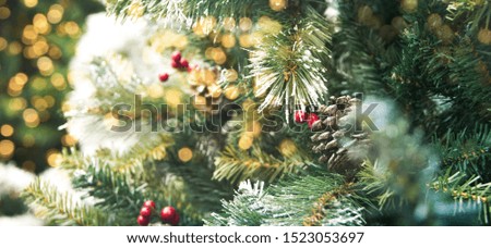 Christmas tree decorated with christmas ornamennts on a blurred, sparkling and fabulous fairy background with beautiful bokeh, copy space.
