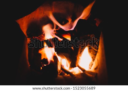 Flame on burning wood and charcoal in fire for food grill.