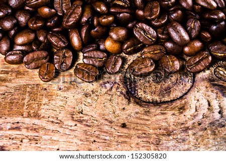 Coffee beans on grunge old wooden background. Coffee concept. Closeup. 
