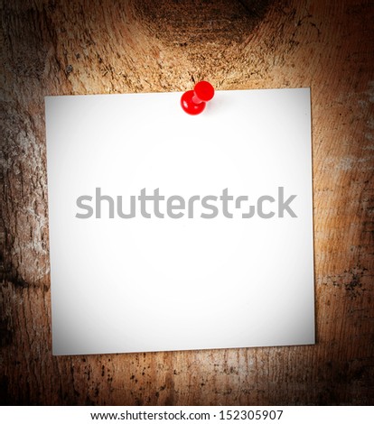 White Paper sheet  reminder With red Push Pin on wooden old background