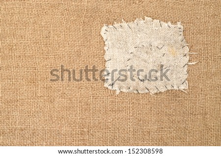 Texture of the old burlap with a patch 