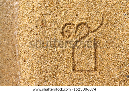 Closeup image of thai letter saaw sooh meaning chain written at yellow beach sand background.