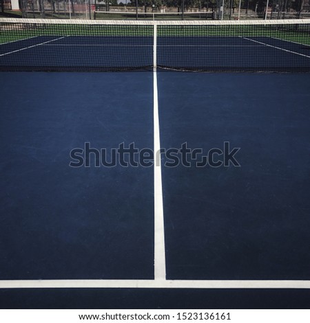 A Tennis Court, Net and White Boundary Lines.