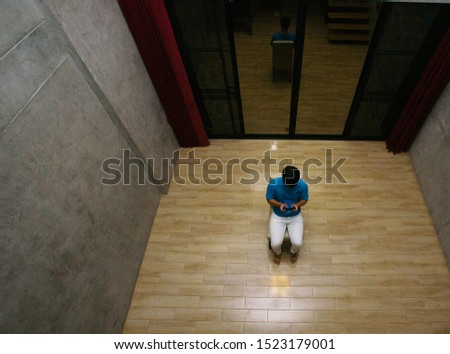 Depressed man sitting alone in dark room, depressive disorder.