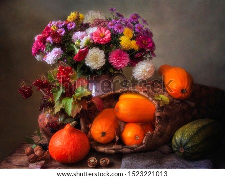 Still life with beautiful bouquet of flowers and autumn harvest