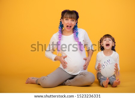 Mom and daughter show their pregnant belly