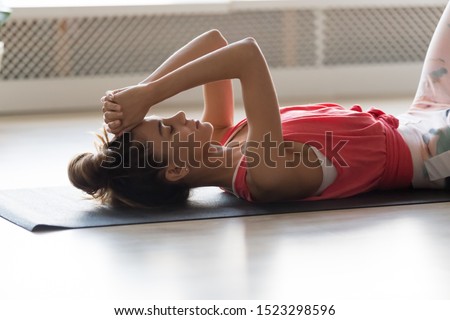 Calm young woman lying on yoga fitness mat relaxing tired after workout training exercises at home gym, mindful serene girl rest with eyes closed laying on floor meditating breathing concept Royalty-Free Stock Photo #1523298596