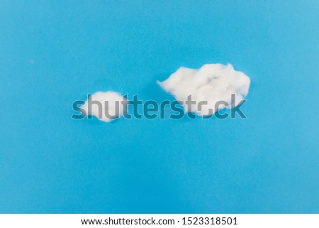 Handmade paper clouds on blue paper as sky
