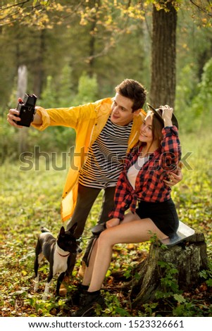 romatic couple taking picture of themselves in the fores with amazing nature. green forest in the background of the photo