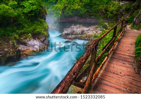 Popular and well known touristic attraction near Bled. Stunning Vintgar gorge with wooden footbridge and emerald color Radovna river, near Bled, Gorje, Slovenia, Europe