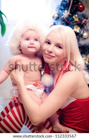 Christmas baby girl with blond hair mother
