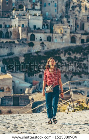 handsome girl travelling in Matera, south of italy, background cityscape of Basilicata, Unesco site, capital of culture 2019