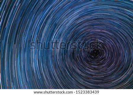 Beautiful starry sky with star trails orientation on the north star. Space background.