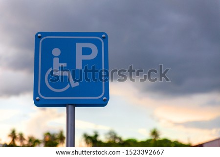 Parking for people with disabilities. Parking stop for disabled people with sunset.