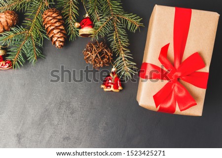 Christmas or New Year background with decorations, pine branch and gift box, top view with copy space.