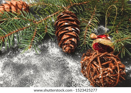 Christmas or New Year background with decorations, pine branch with toys and cones, copy space.