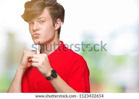 Young handsome man wearing red t-shirt over isolated background Ready to fight with fist defense gesture, angry and upset face, afraid of problem