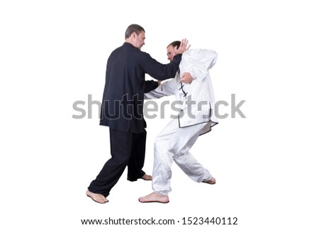 Adult athlete performs formal goju-ryu exercises. It is isolated in a white background. Close-up.