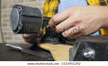 close-up.Man hands who repair a broken electric skateboard. unscrews the wheels