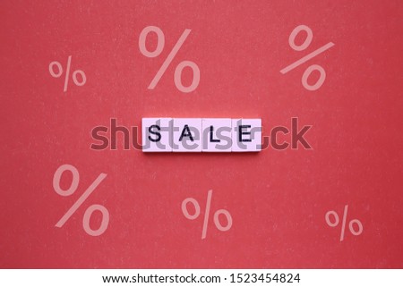 Sale word wooden cubes on a red background