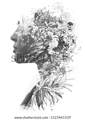 Paintography. Double exposure of woman's profile dissolving into hand drawn leaves, black and white