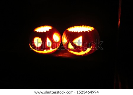 Halloween pumpkin head jack lantern on dark grass background