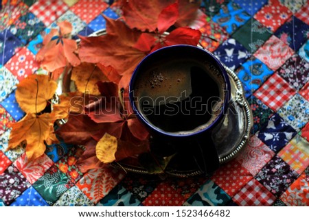 Morning Coffee In A Cafe, Blue Coffee Cup Drink on on iron vintage tray.Black espresso coffe. Cup of fresh coffee on colorful patchwork overlay background, top view with autumn leaves. Autumn concept 
