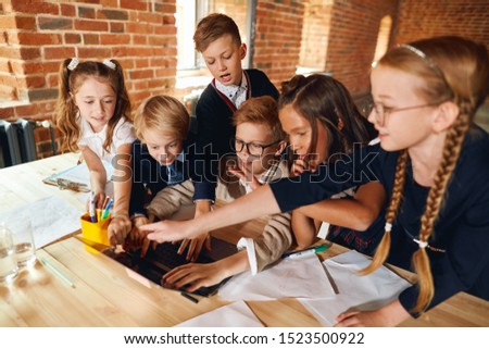 funny little kids pointing to the screen, doing shopping online, pastime, leisure , close up photo