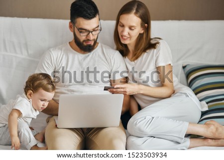 good looking young family paying for laon, doing shopping online. close up photo.