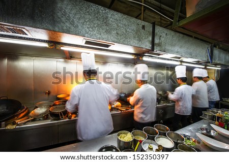 Crowded kitchen, a narrow aisle, working chef. Royalty-Free Stock Photo #152350397