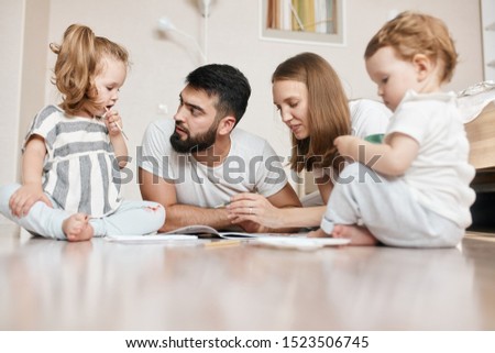 young father and mother spending weekend with their children, they preparing a picture for holiday, close up photo
