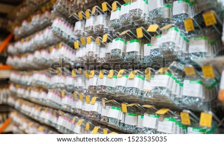 Rows of boxes with bolts in hardware store closeup