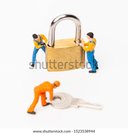 The concept of a collective solution to any problem. Miniature toy workers and security key using as background security system, hack, business concept.
