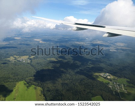 Airplane wing in flight. View from the porthole.