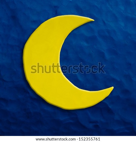 Color children's moon plasticine on a dark blue background 